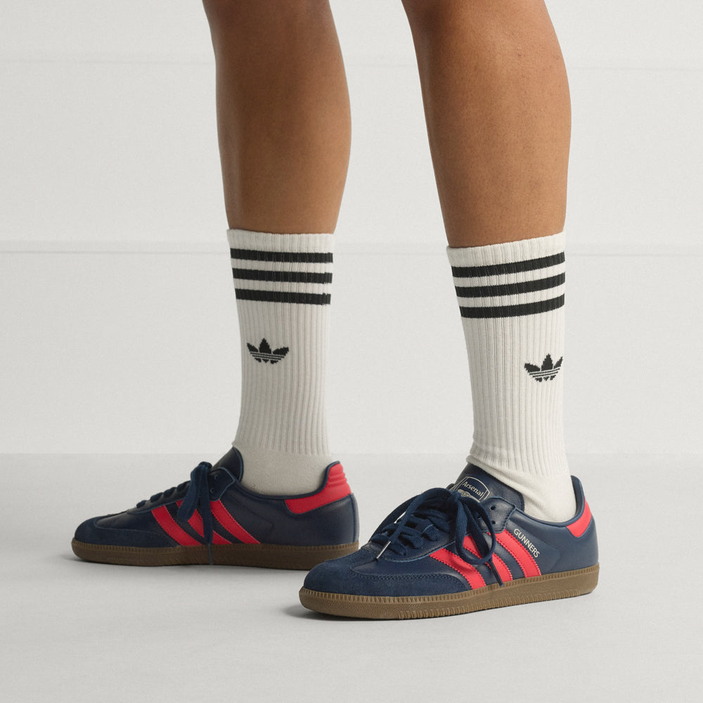 Side view of Adidas Samba OG sneakers highlighting the rubber cupsole