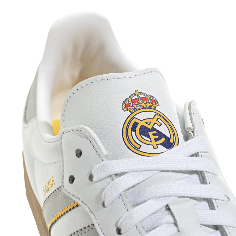 Side profile of Samba OG on-foot with cuffed denim, highlighting the slim silhouette and gum rubber cupsole