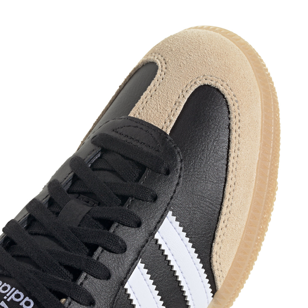 Side view of Adidas Samba OG youth shoes highlighting the gum rubber sole