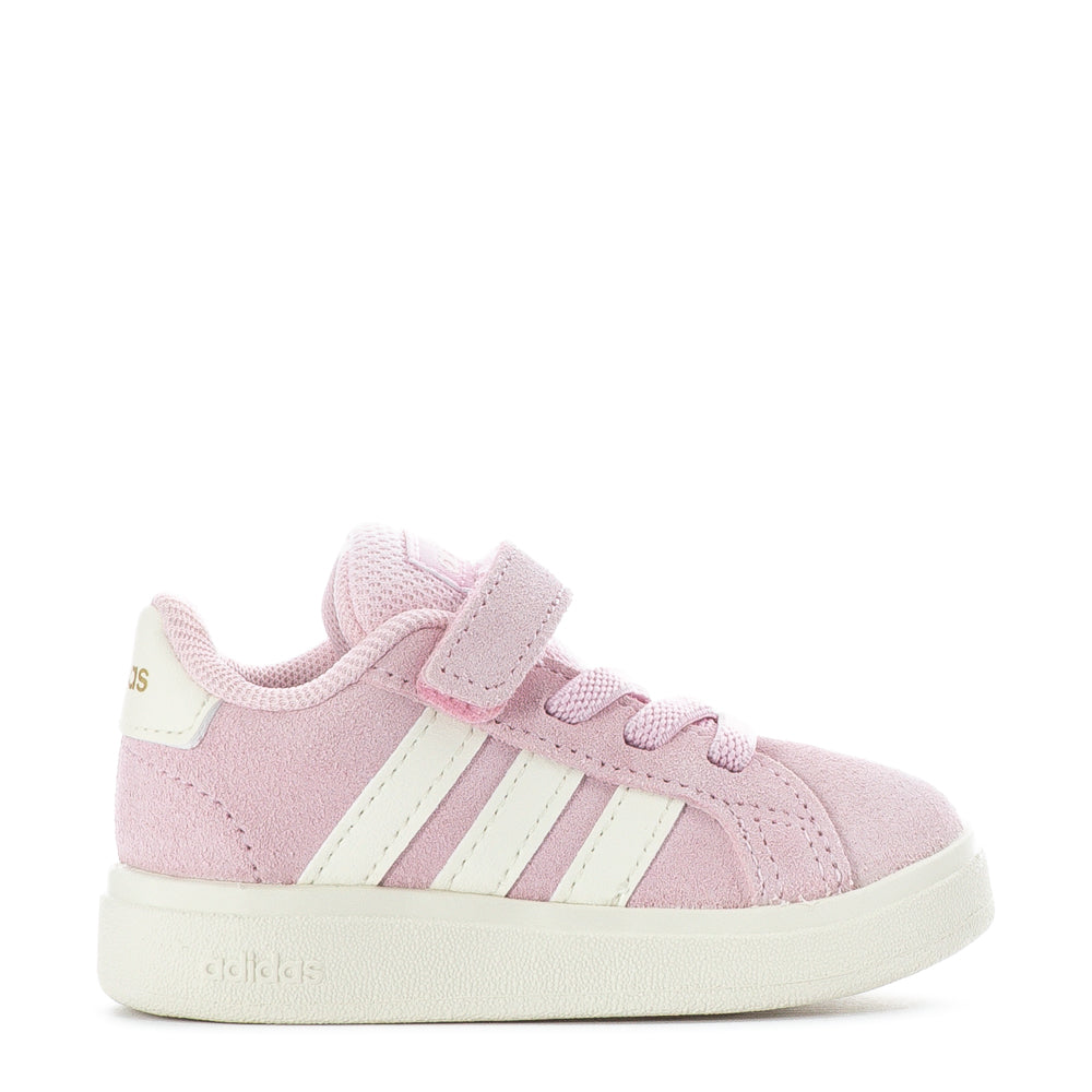 Toddler wearing supportive baby sneakers for walking outdoors