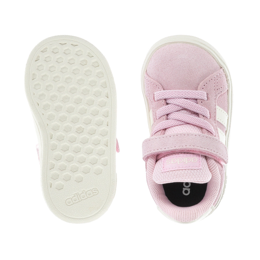 Toddler wearing supportive baby sneakers for walking outdoors