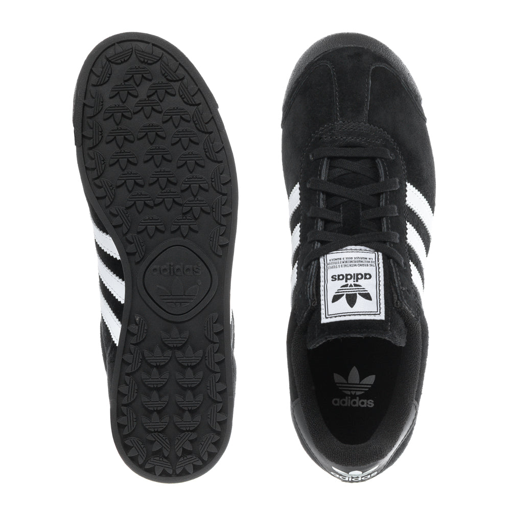 Close-up of adidas Samoa youth sneakers showing leather upper and rubber toe bumper