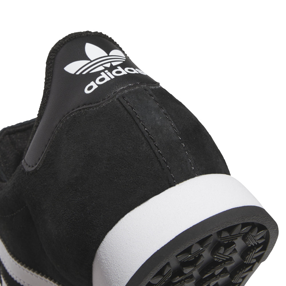Close-up of adidas Samoa youth sneakers showing leather upper and rubber toe bumper