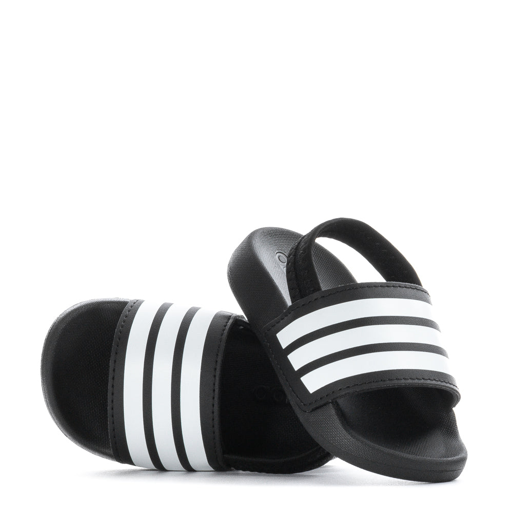 Side view of Adilette Estrap toddler slides on a playful child