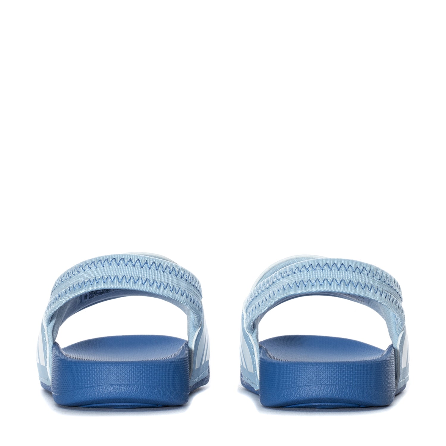 Child wearing adidas slides outdoors during summer play