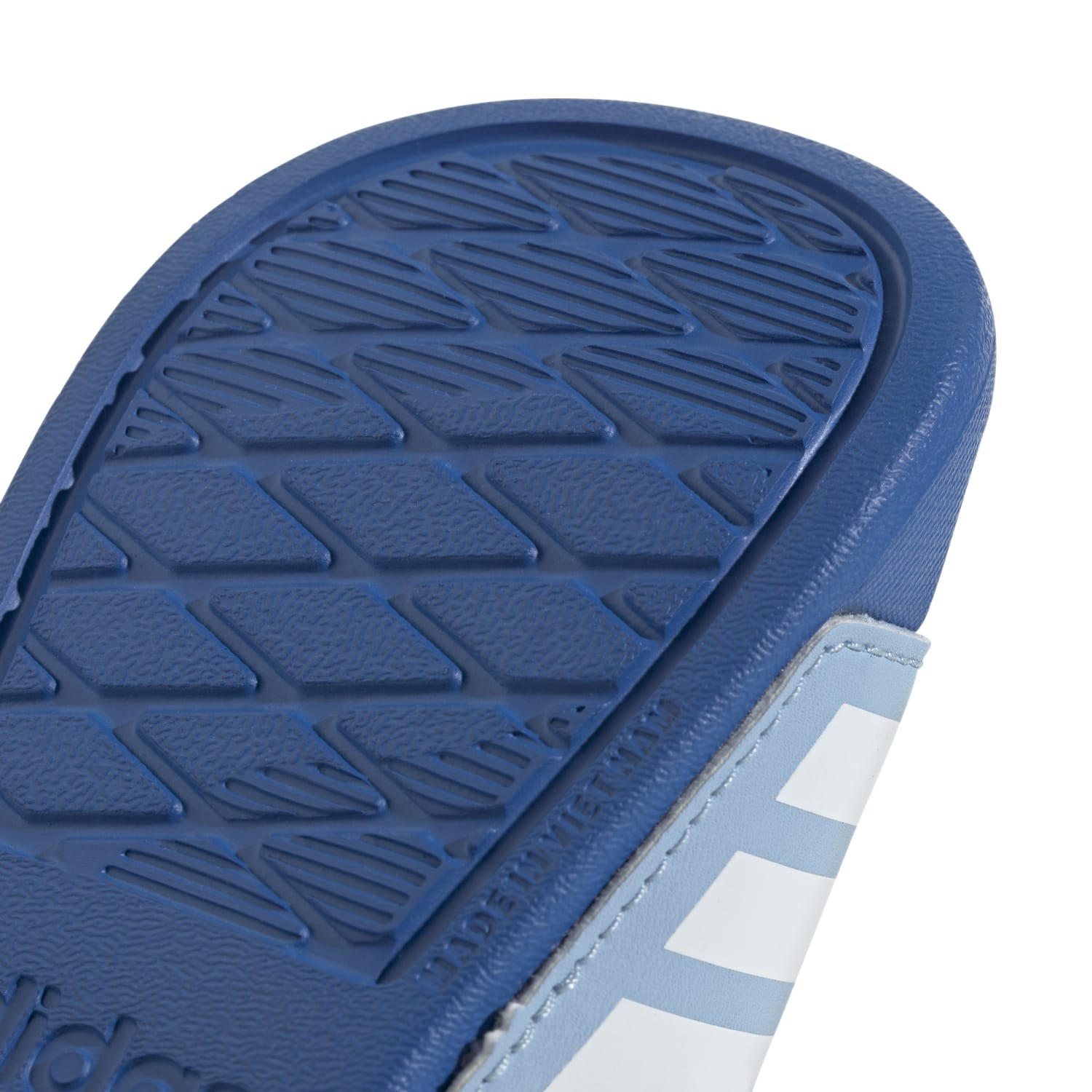 Side view of adidas toddler slides showing slip-on design and synthetic upper