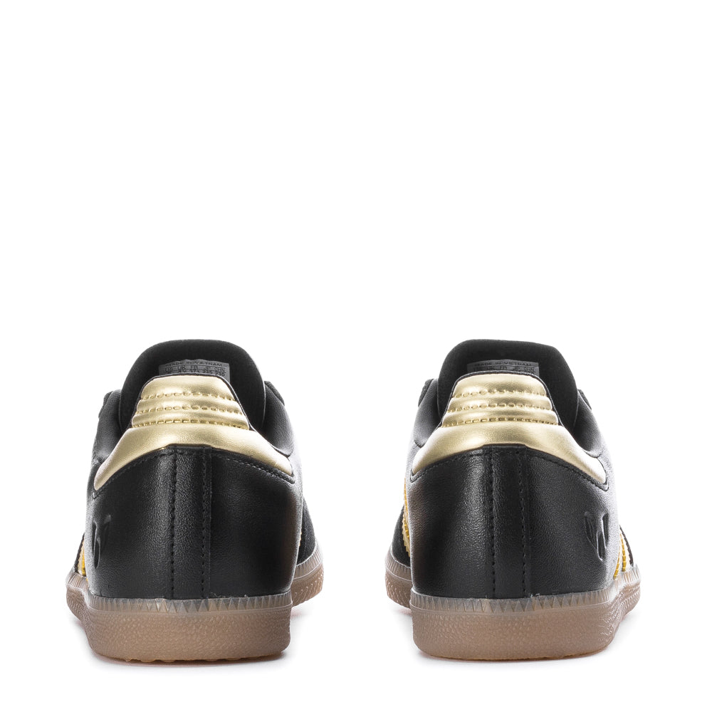 Close-up of the Adidas Samba OG kids sneakers, highlighting the leather upper and gum rubber sole.
