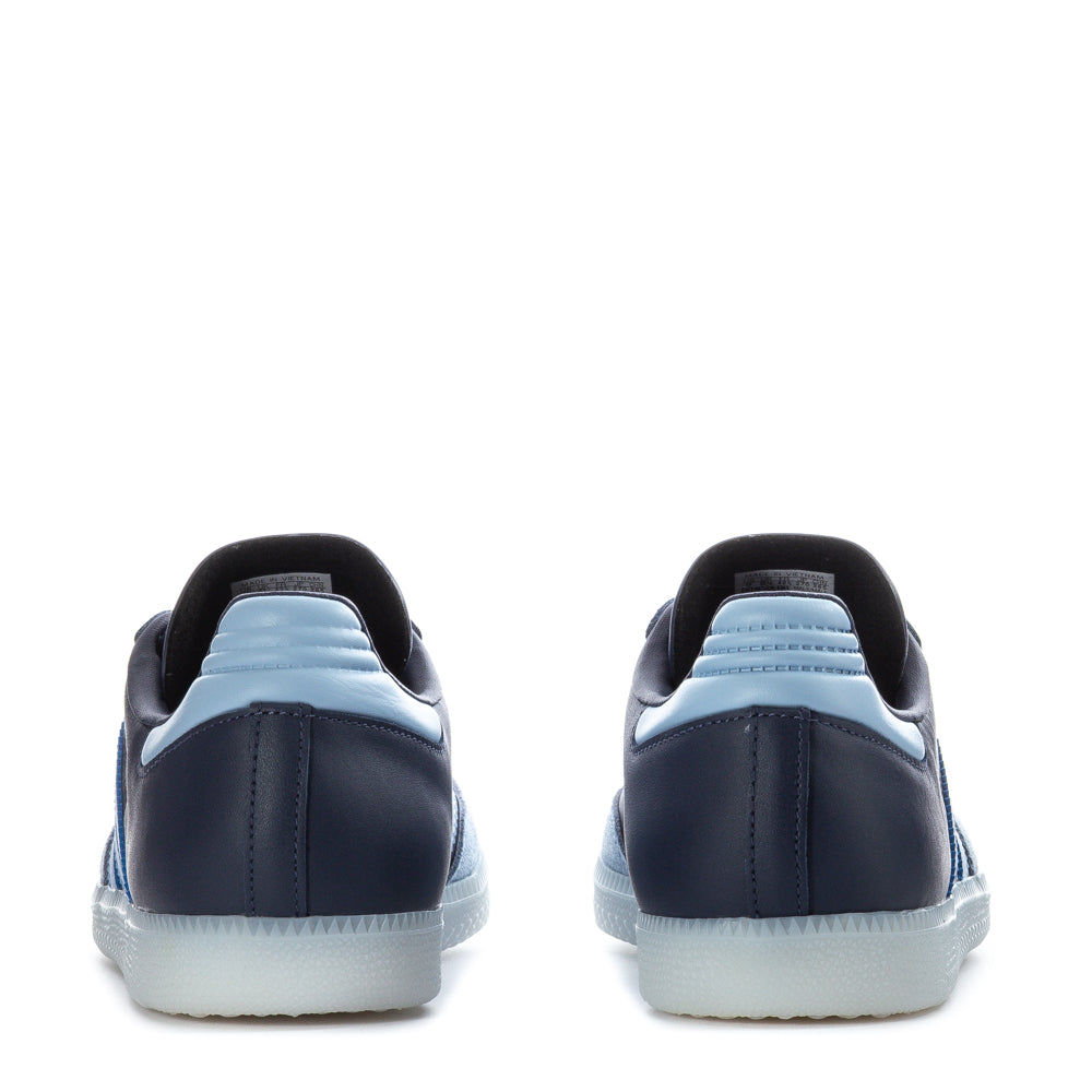 Close-up of the Adidas Samba OG sneakers highlighting the serrated 3-Stripes and contrast lace overlays.