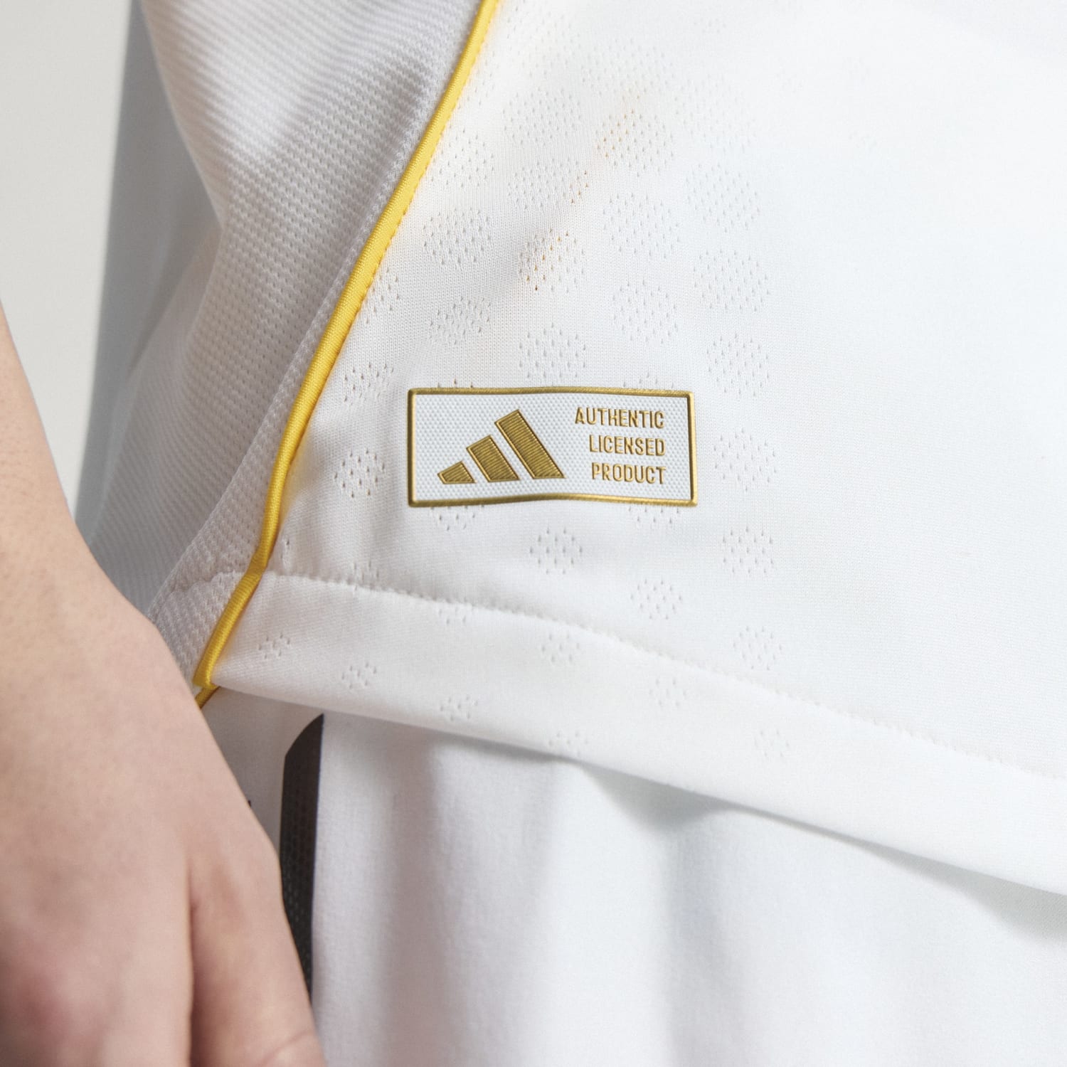 Front view of the 2025 Real Madrid authentic home jersey showcasing the team logo.