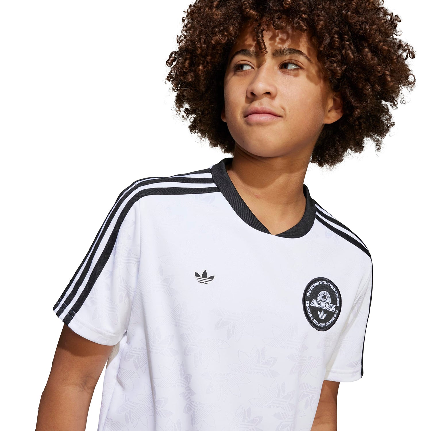 Youth active sport tee in a dynamic pose during an outdoor game.