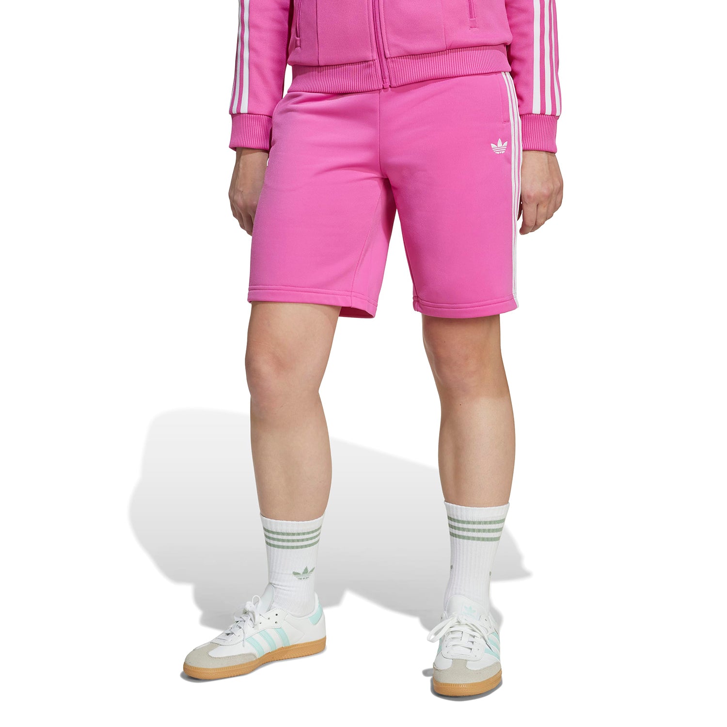 Child wearing athletic shorts while running outdoors for sports practice