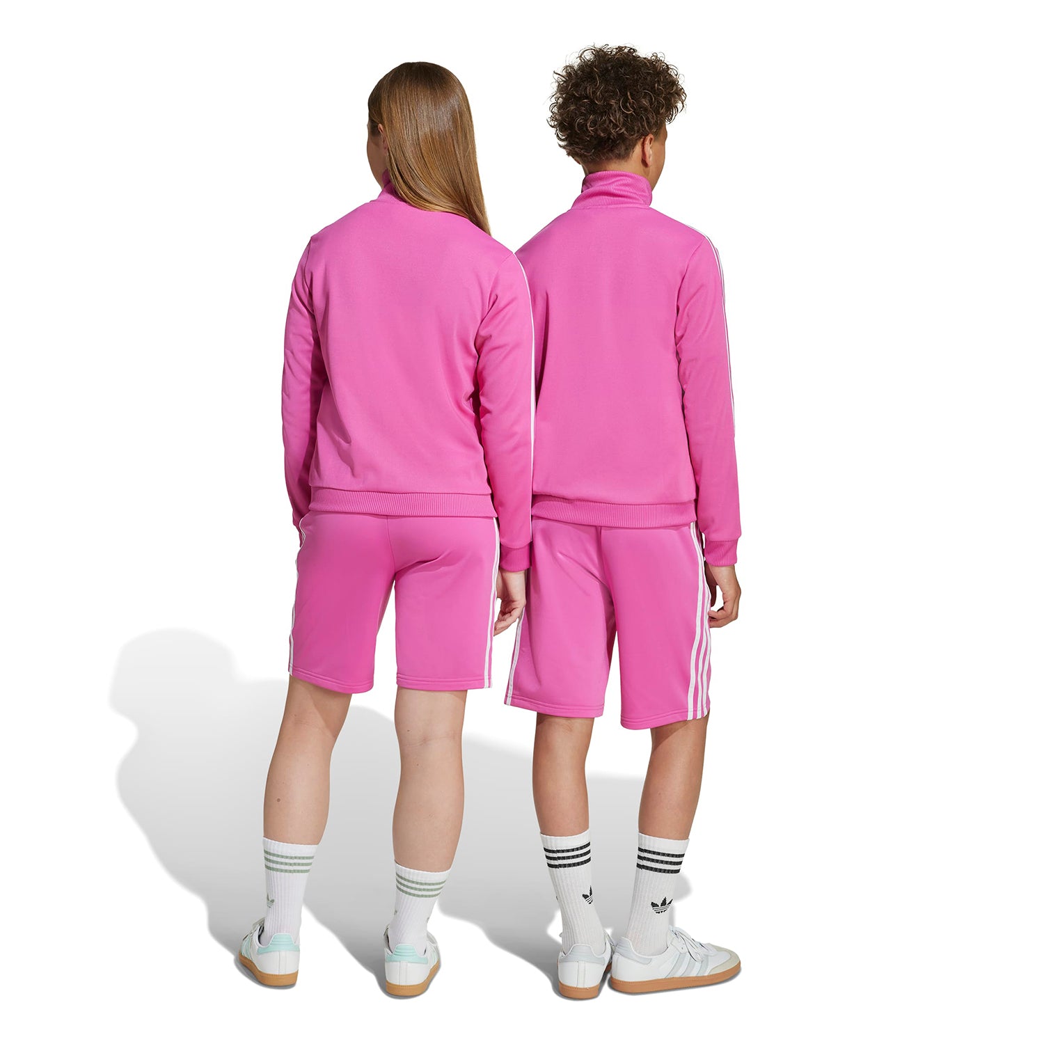 Child wearing athletic shorts while running outdoors for sports practice