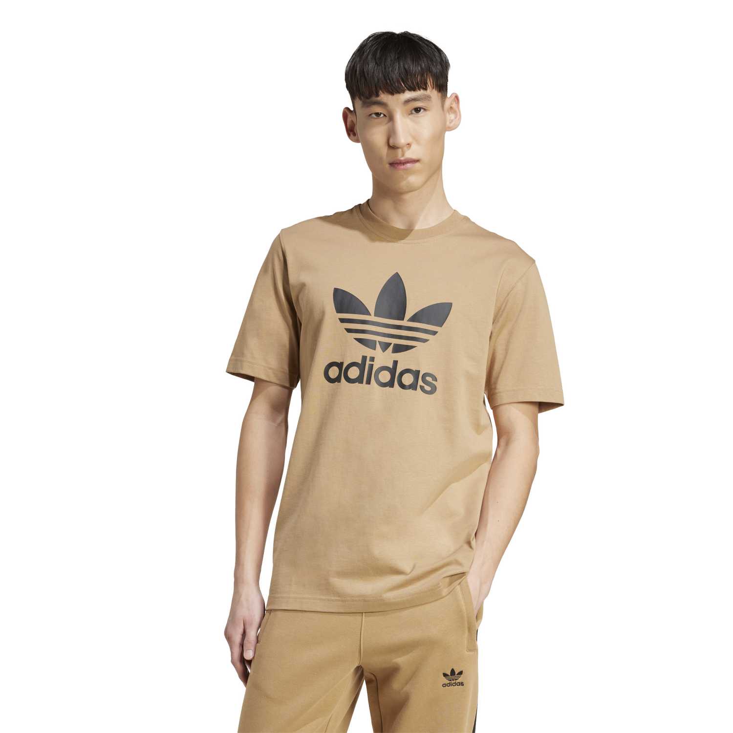Side view of the Adidas tee, demonstrating its classic fit and ribbed crewneck.