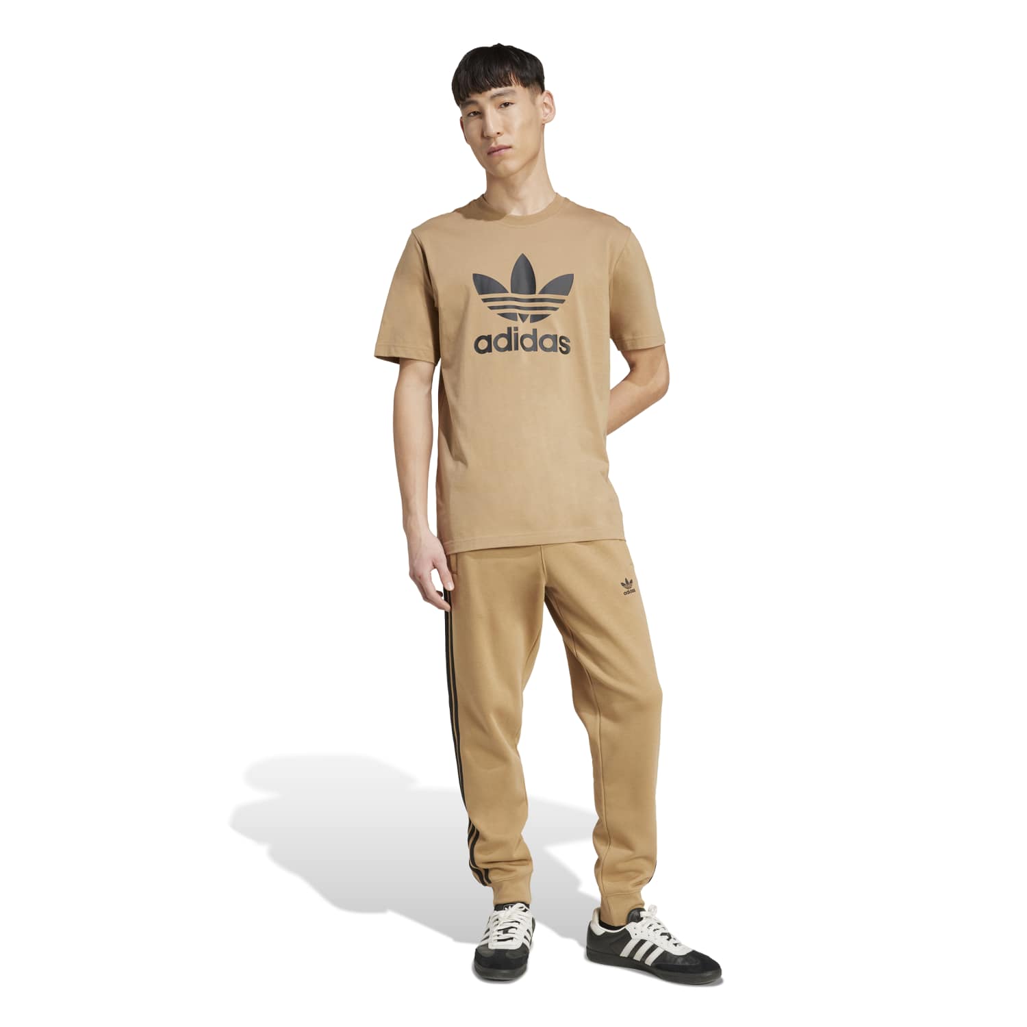 Casual outfit featuring the Adidas Trefoil Tee paired with shorts and sneakers.
