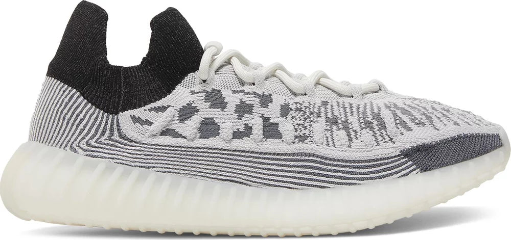 Side view of Adidas Yeezy 350 V2 Panda sneakers highlighting the black and white colorway