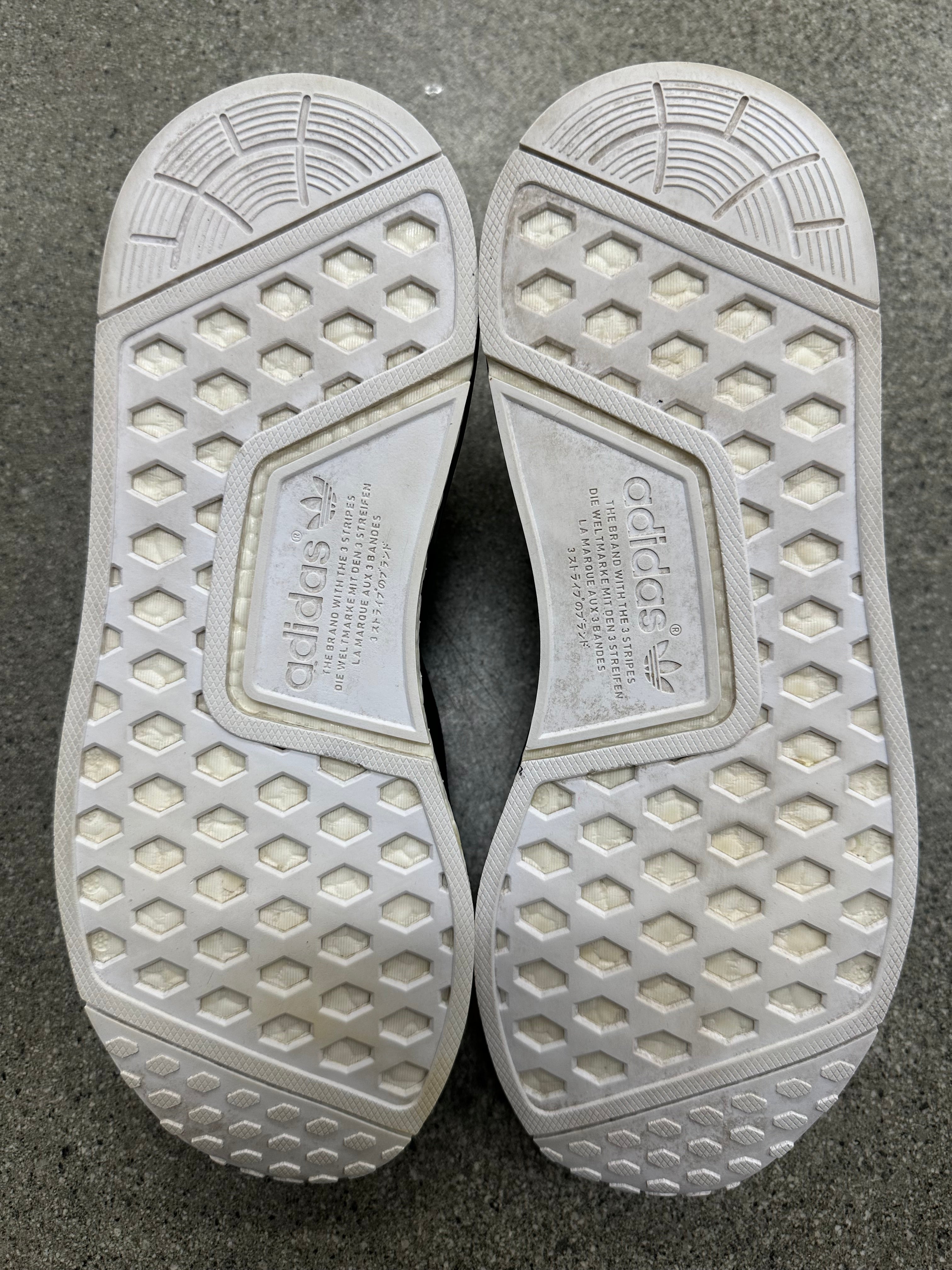 Side view of adidas human race NMD black sneakers, size 10, worn condition, detailed design