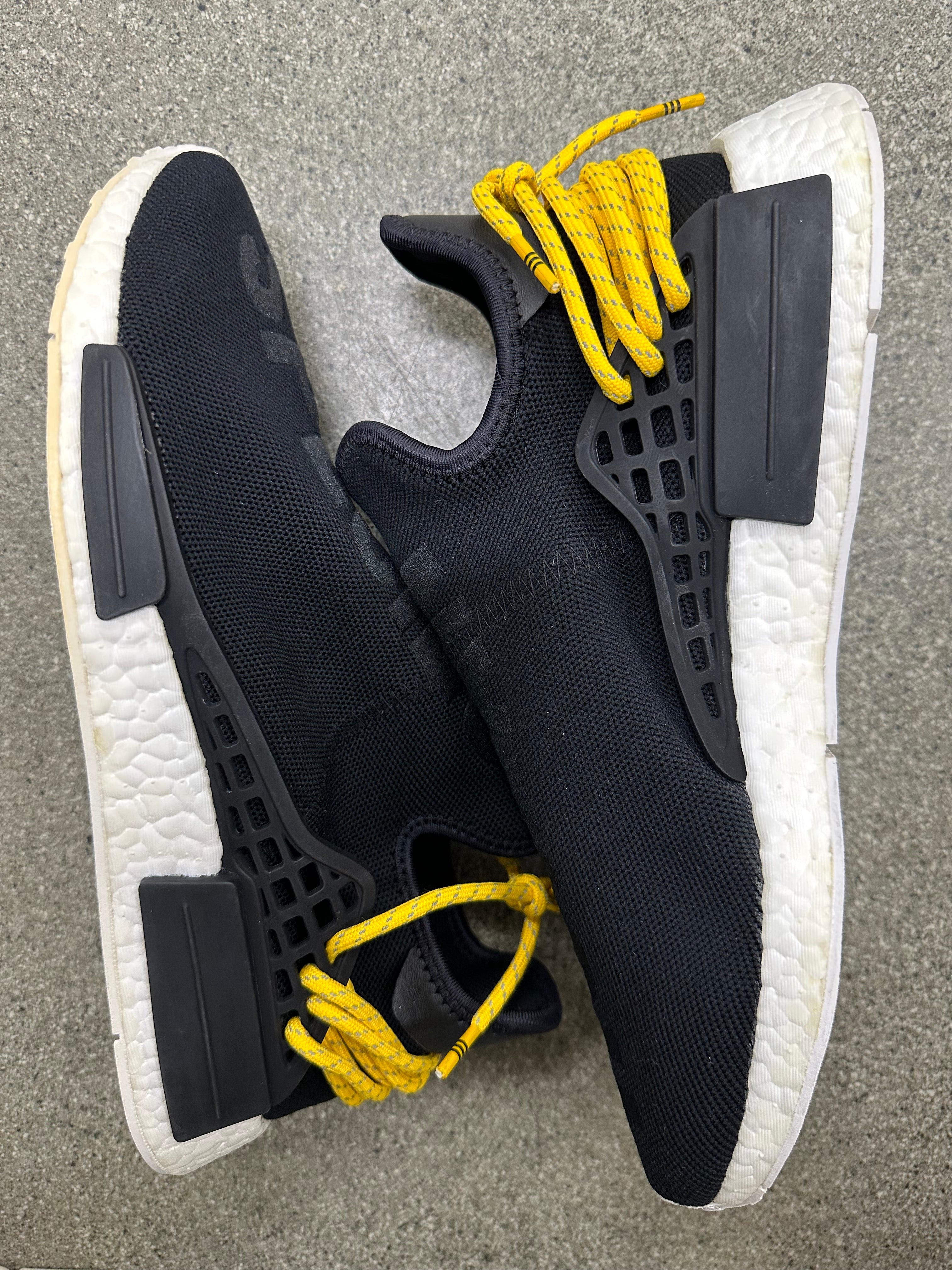 Side view of adidas human race NMD black sneakers, size 10, worn condition, detailed design