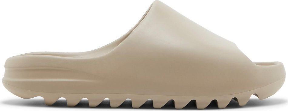 Front view of Adidas Yeezy Slide Pure in white, highlighting its sleek design