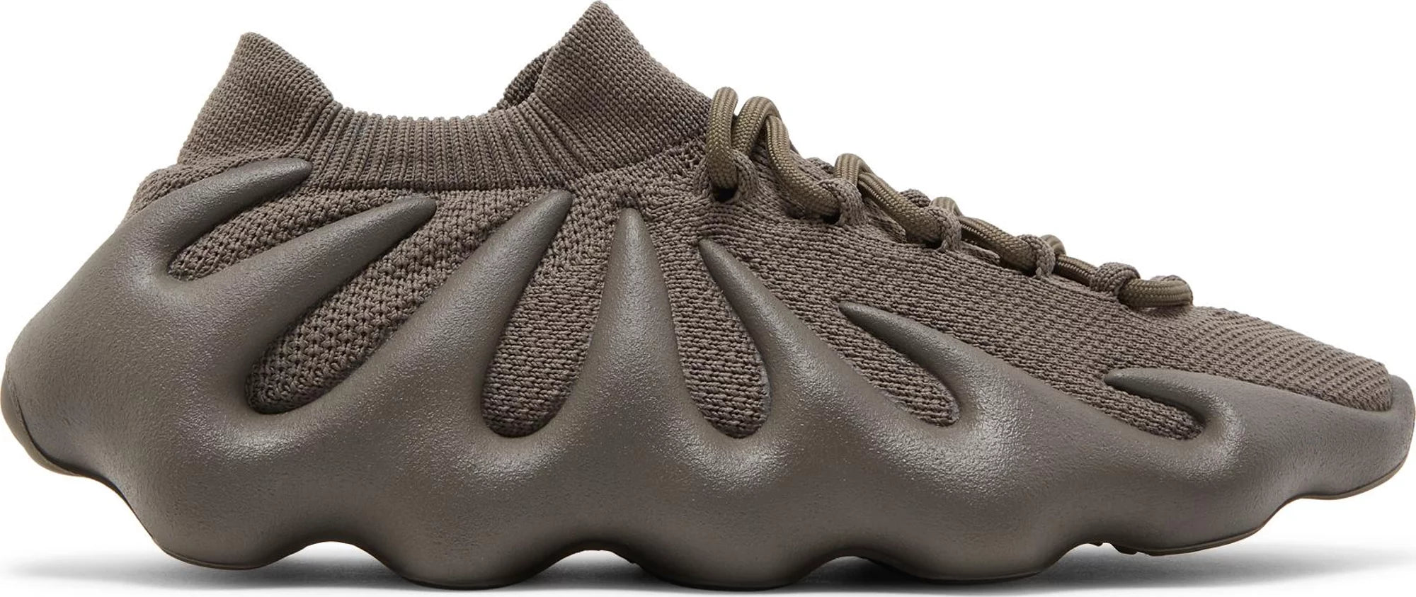 Top-down view of Adidas Yeezy 450 CINDER sneaker on light wood floor, showing tonal knit and claw-like midsole