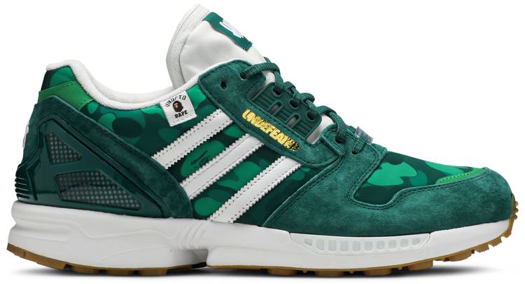 Adidas ZX 8000 BAPE sneakers displayed on a concrete surface, emphasizing their stylish green color and streetwear appeal.