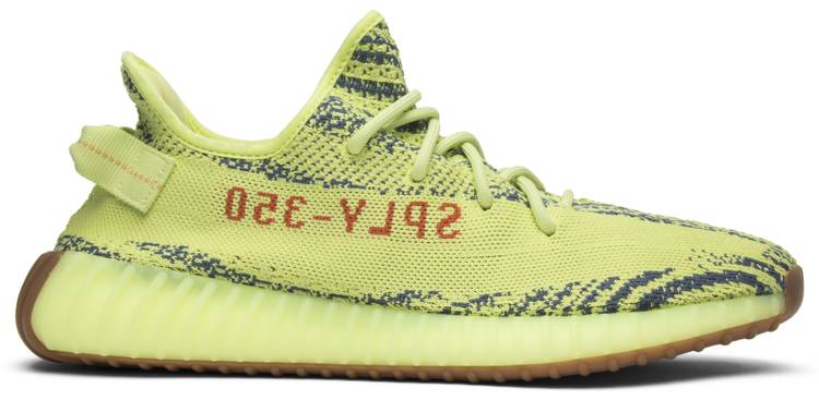 Close-up view of Adidas Yeezy 350 V2 Semi Frozen Yellow sneakers showcasing the unique color and design.