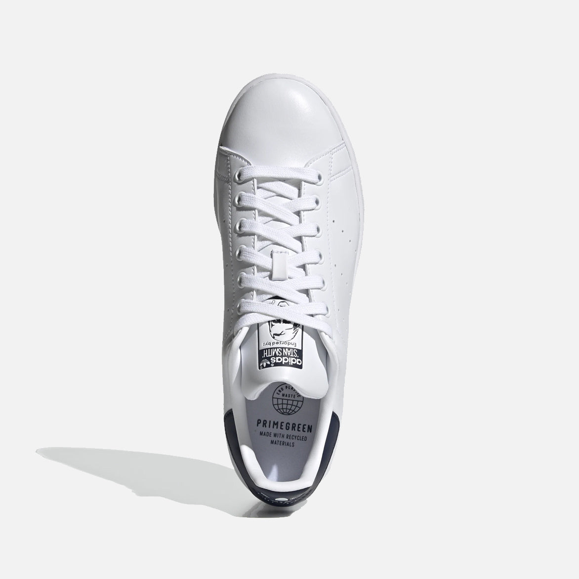 Top-down view of Adidas Stan Smith shoes highlighting the clean white leather.
