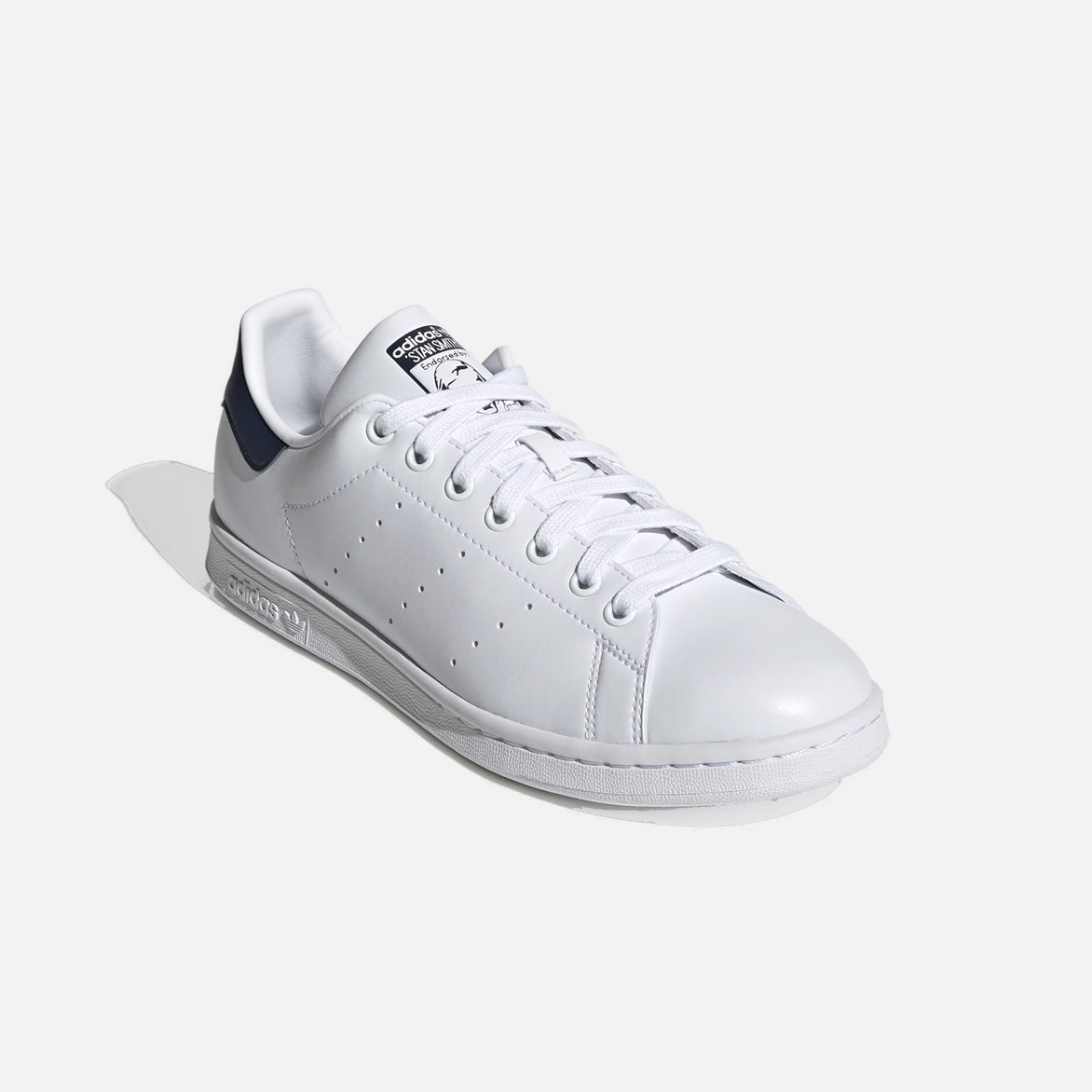 Side view of Adidas Stan Smith white sneakers showcasing perforated 3-Stripes.