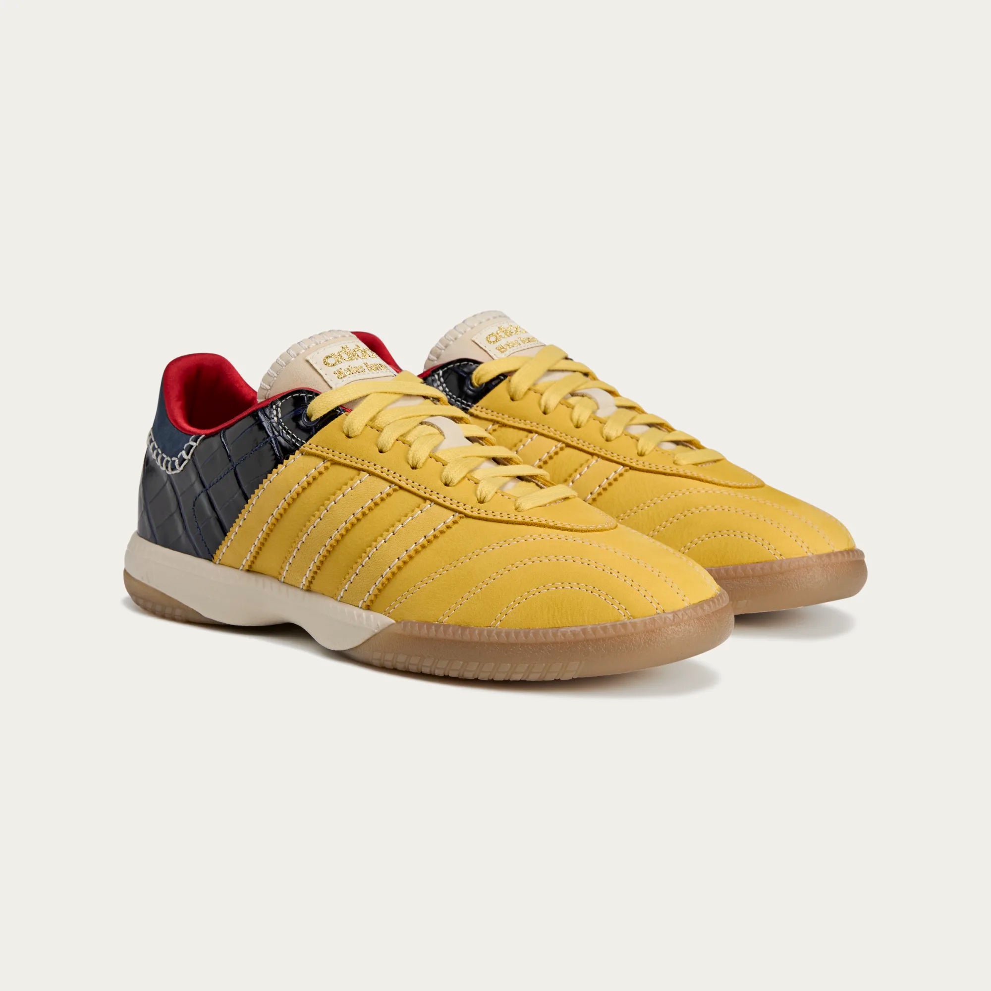 Detailed shot of the yellow suede panels and navy croc-textured leather on the Millennium Samba sneakers