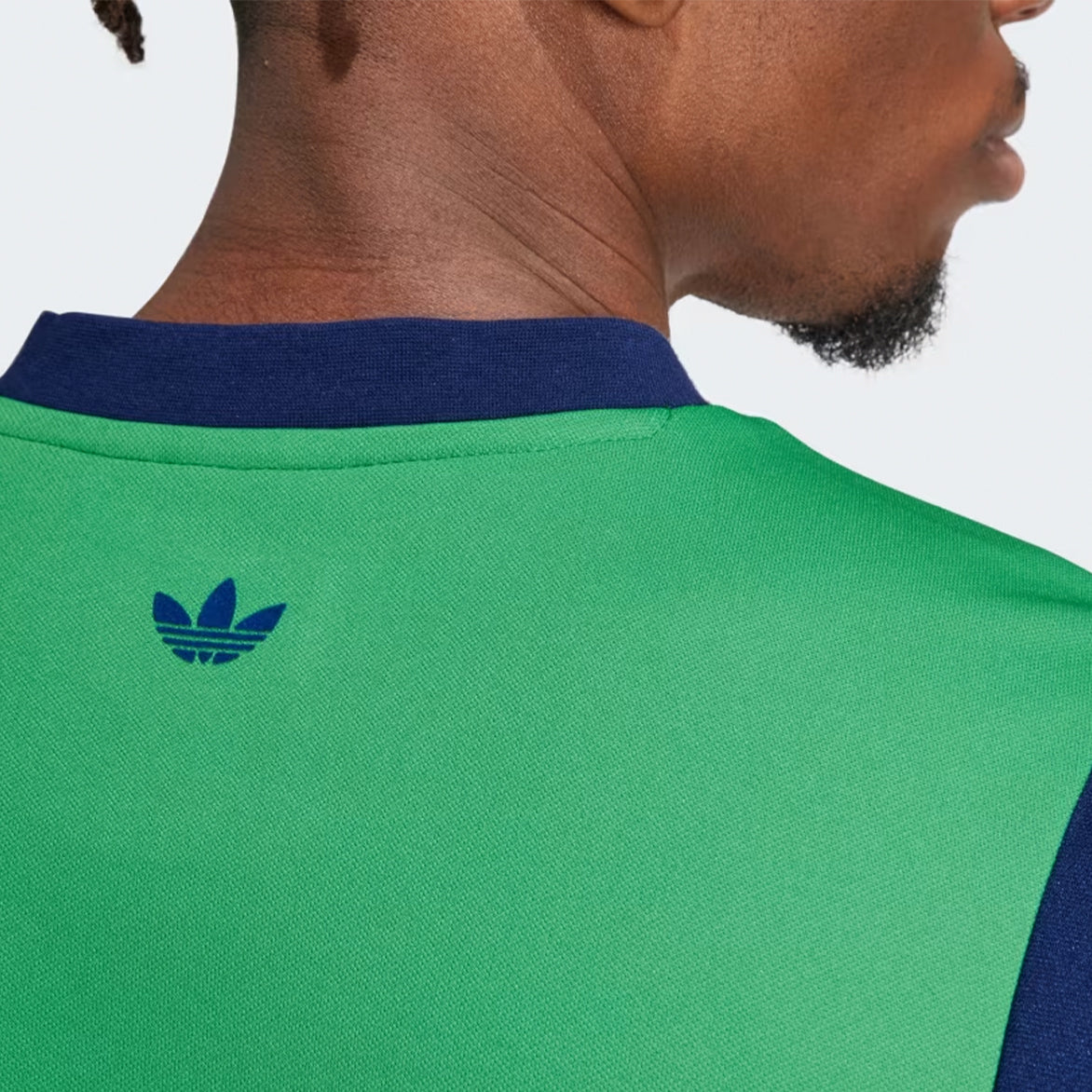 Front view of Wales Bonner x adidas shirt in vivid green with blue accents