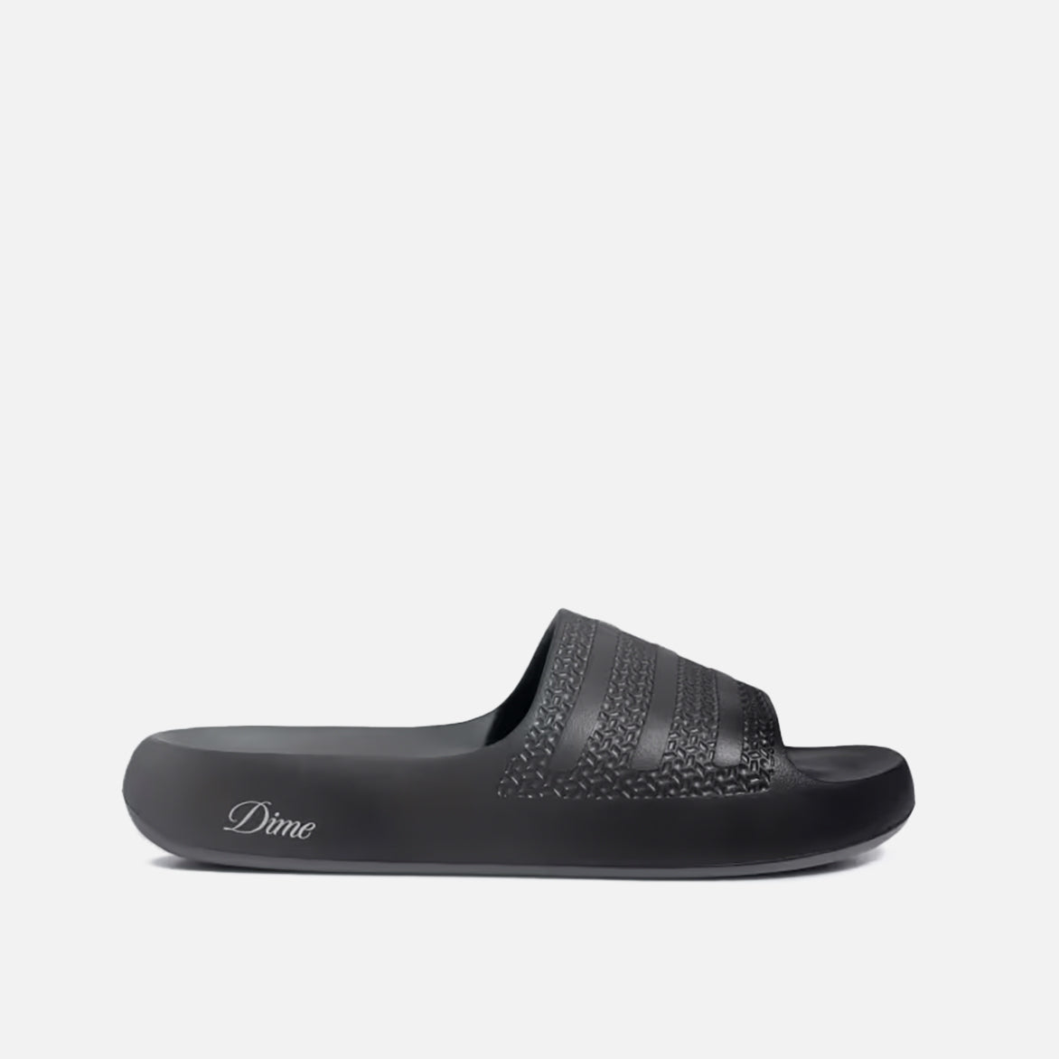 Close-up of Dime x Adidas Ayoon slides showing the sleek synthetic upper and metallic accents
