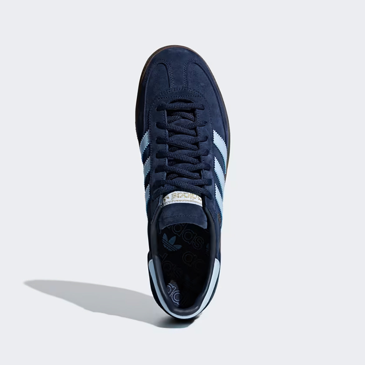 Front view of blue suede sneakers with tonal laces and vintage design