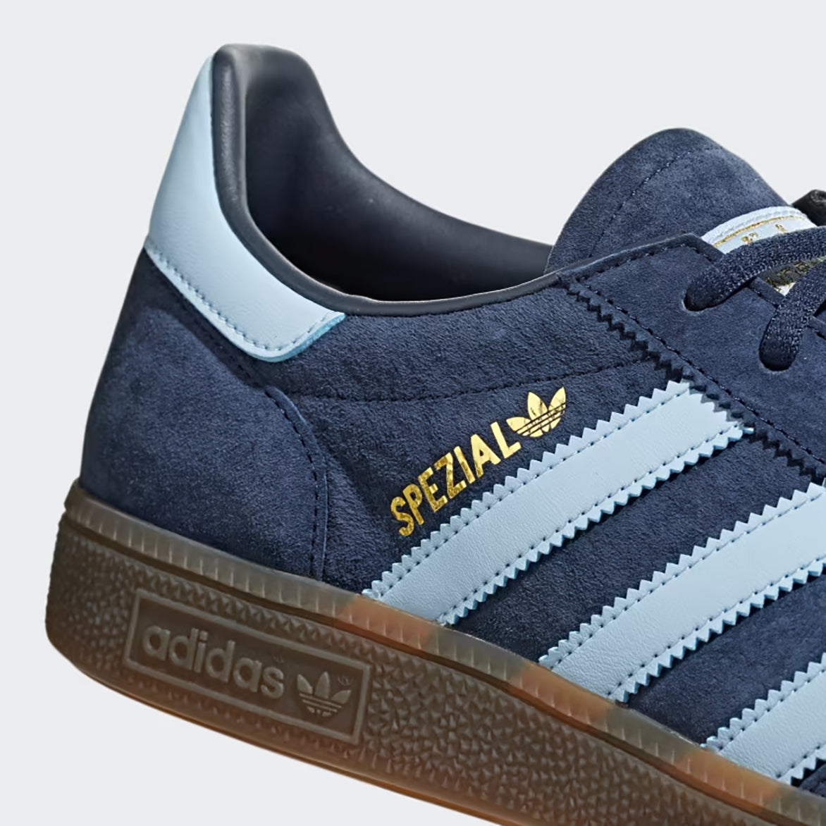 Close-up of the heel tab and gold foil branding on retro sneakers