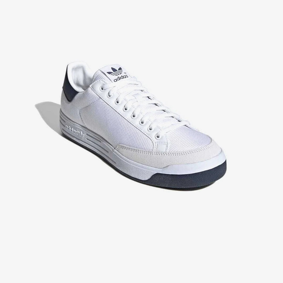 Close-up of Adidas Rod Laver sneakers showing the suede toe cap and Trefoil branding.