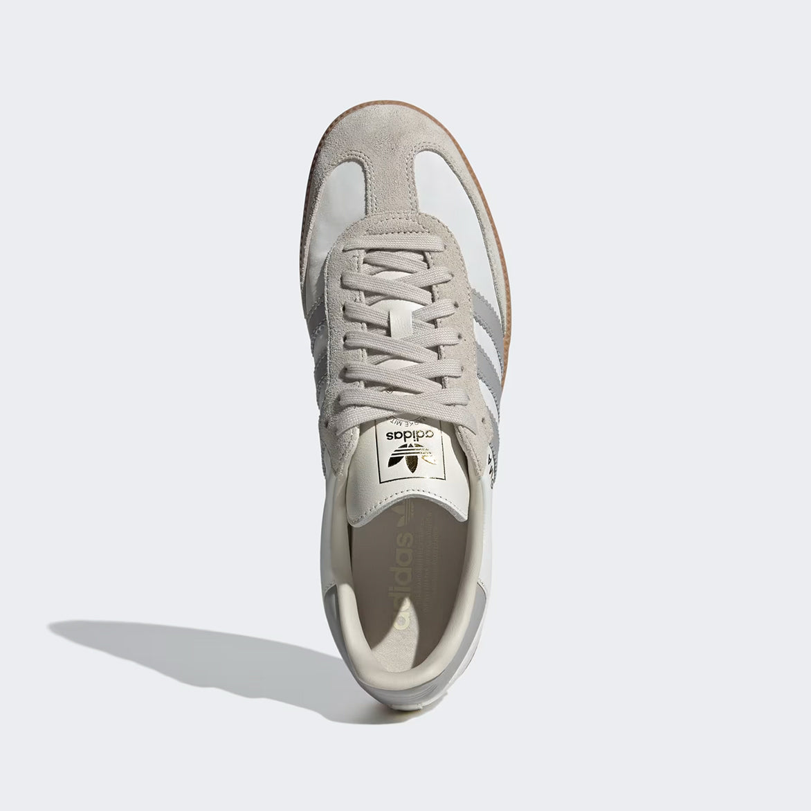 Front view of Adidas Samba OG sneakers highlighting the white leather and grey overlays