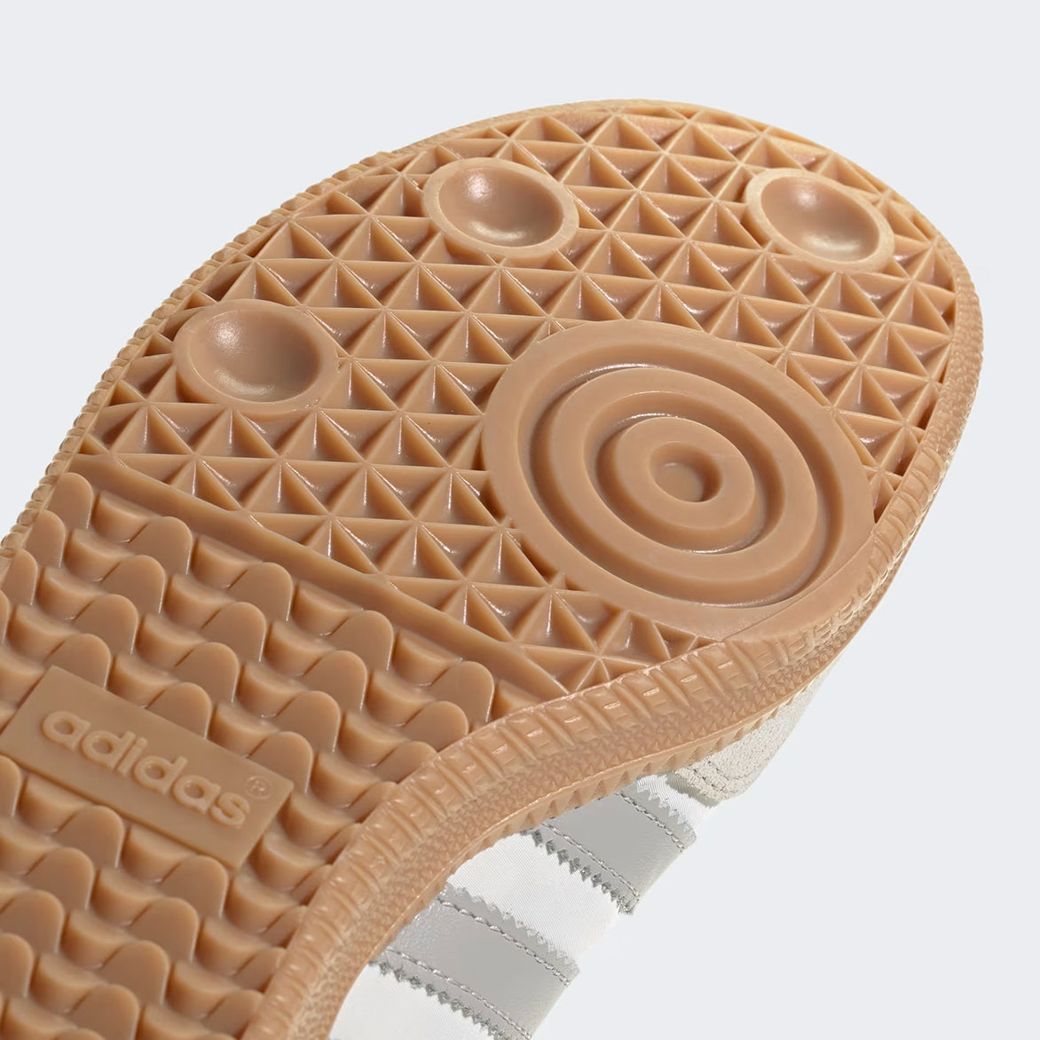 Close-up of the gum rubber outsole and branding details on Adidas Samba OG shoes