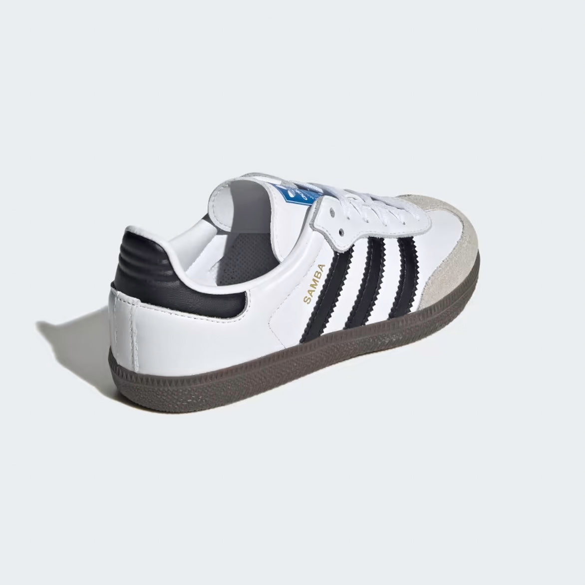 Side view of Samba OG kids sneakers showing white leather and black stripes