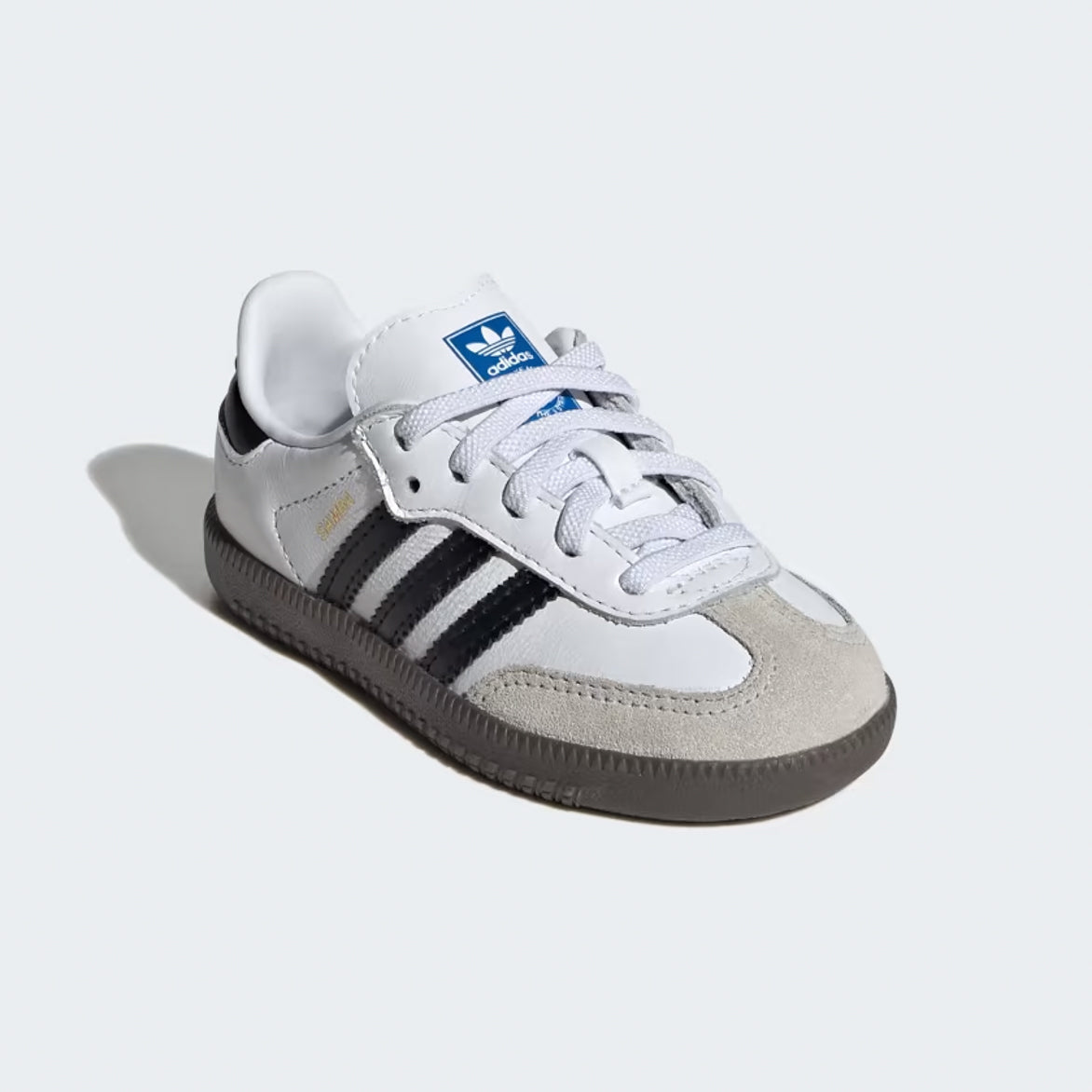 Close-up of Adidas Samba OG sneakers showing the grey suede toebox and black synthetic leather details.