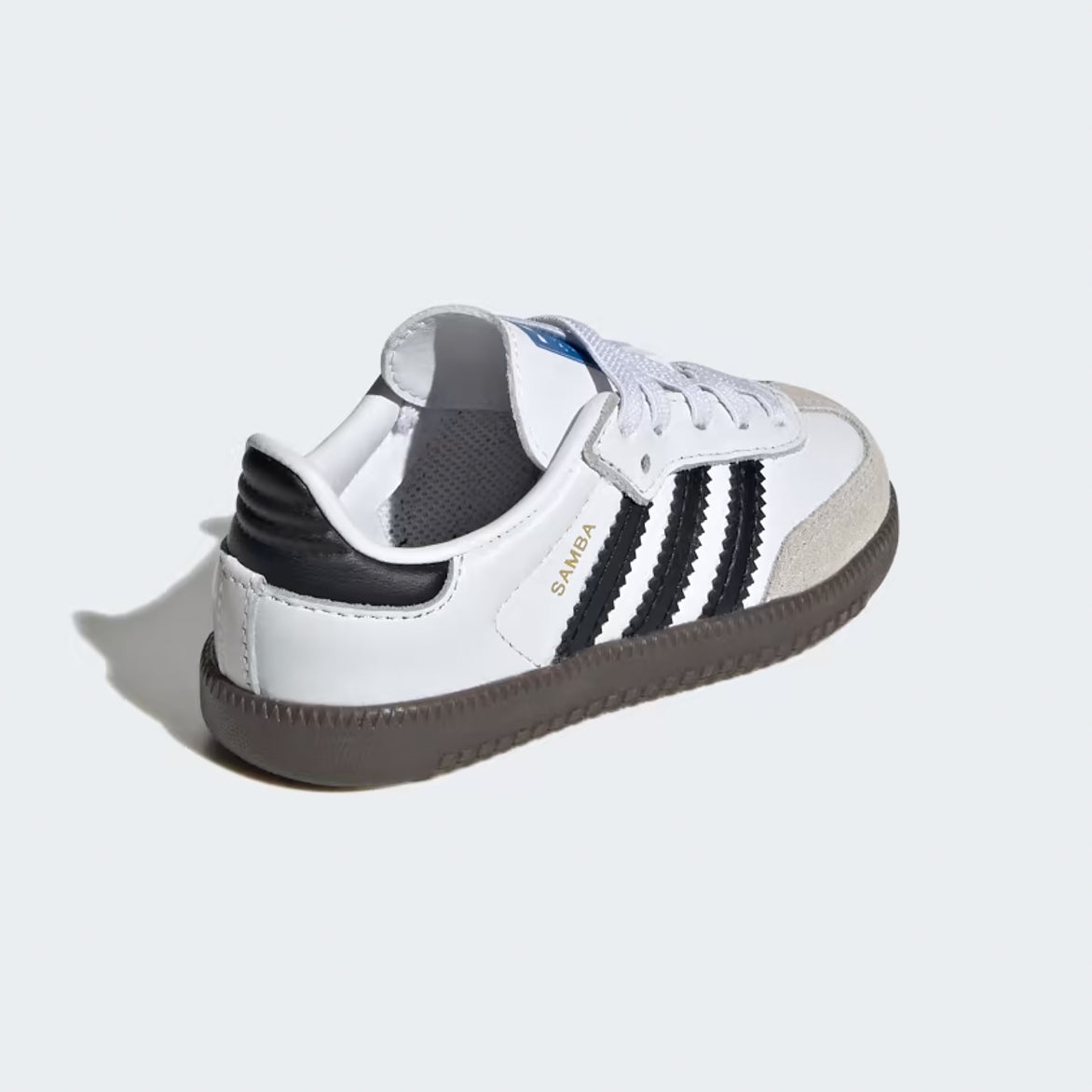 Adidas Samba OG kids sneakers worn by a child during outdoor play, demonstrating their athletic appeal.