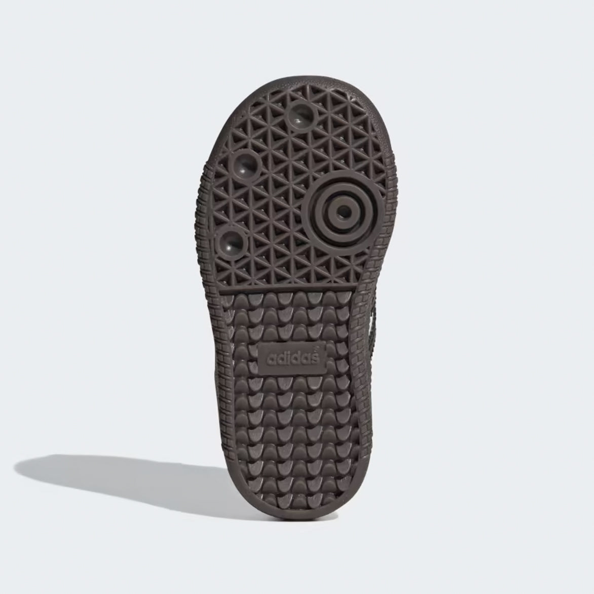Adidas Samba OG kids sneakers worn by a child during outdoor play, demonstrating their athletic appeal.