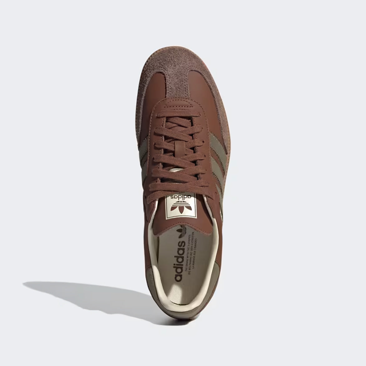 Top view of Adidas Samba OG shoes highlighting the suede toebox and tonal brown laces.
