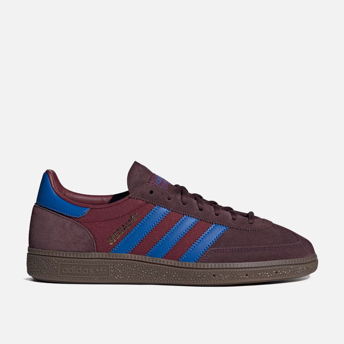 Close-up of Adidas Handball Spezial Night Red sneakers highlighting the suede texture and blue leather details.