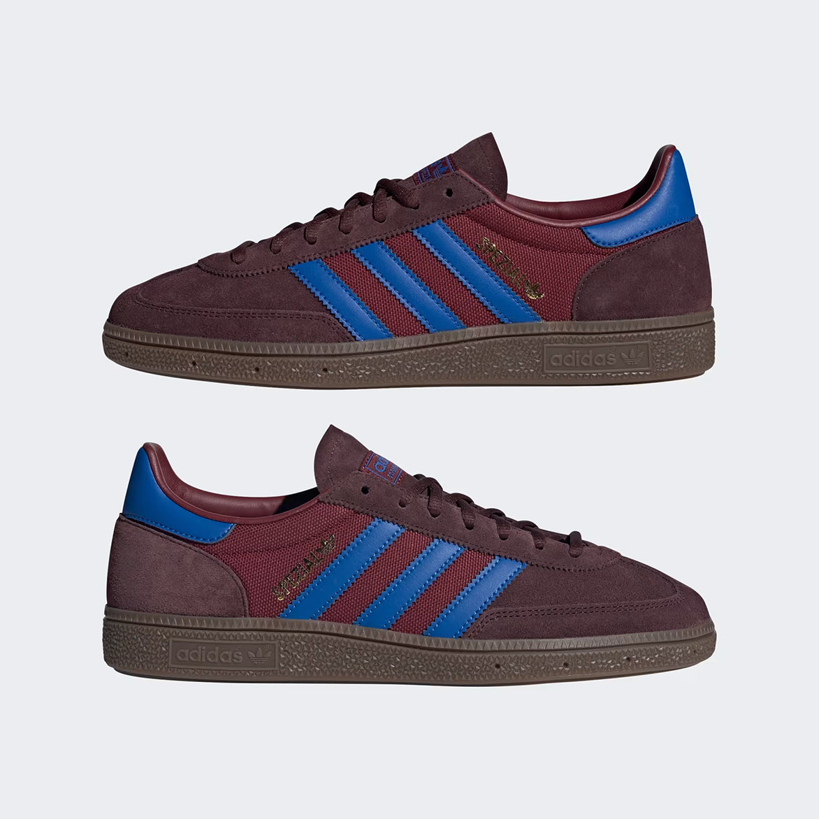 Side view of limited edition Adidas Handball Spezial Night Red sneakers on a casual outdoor setting.