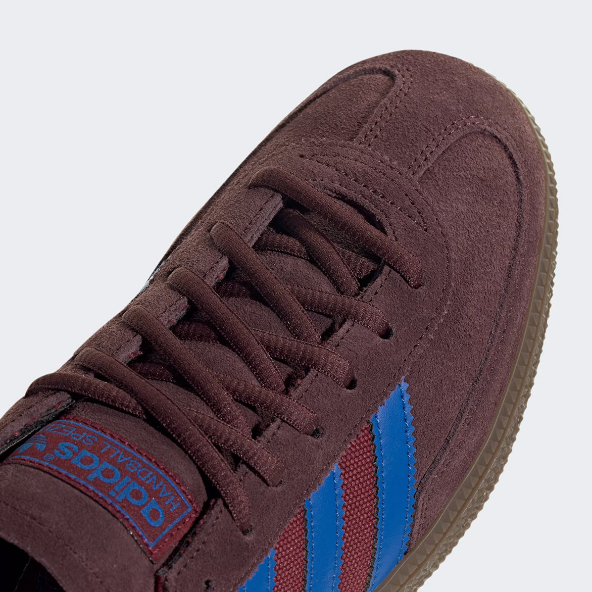 Top-down view of Adidas Handball Spezial Night Red with focus on the tonal laces and gold foil branding.