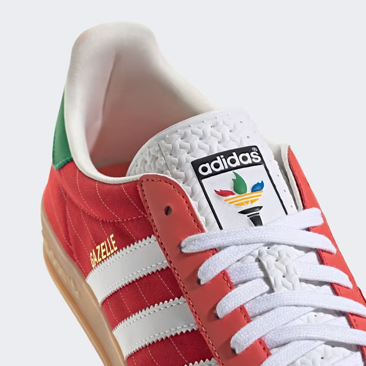 Adidas Gazelle Indoor sneakers in Better Scarlet and Cloud White, showcasing the side view with Three Stripes.
