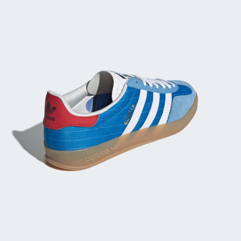 Adidas Gazelle Indoor bright blue sneakers with white leather Three Stripes and gum sole from the side angle.