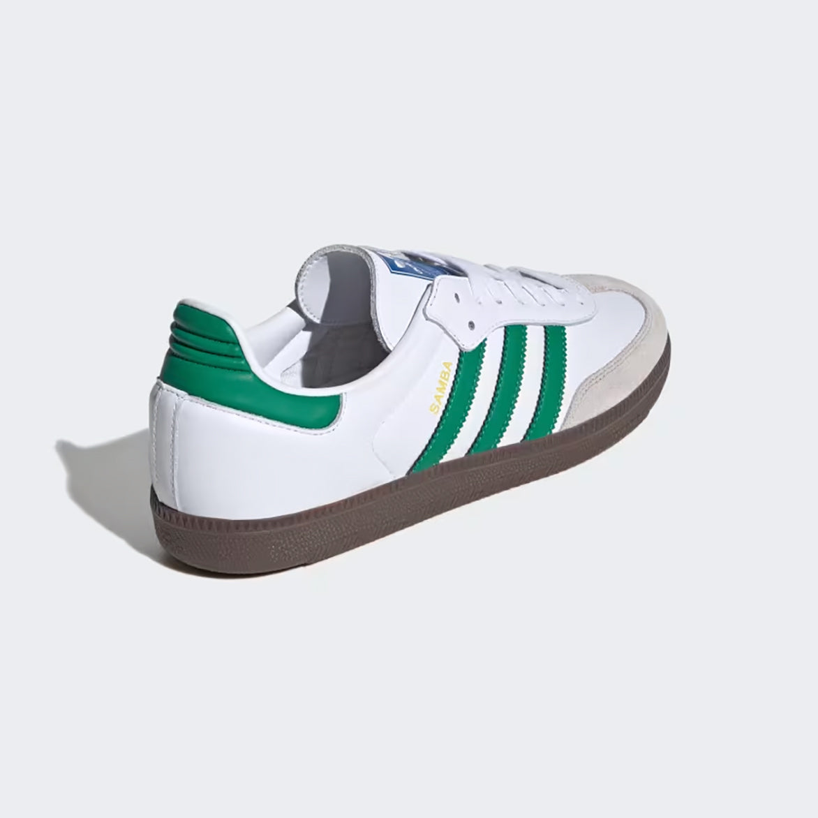 Side angle of Adidas Samba OG Cloud White Green limited edition sneakers on concrete