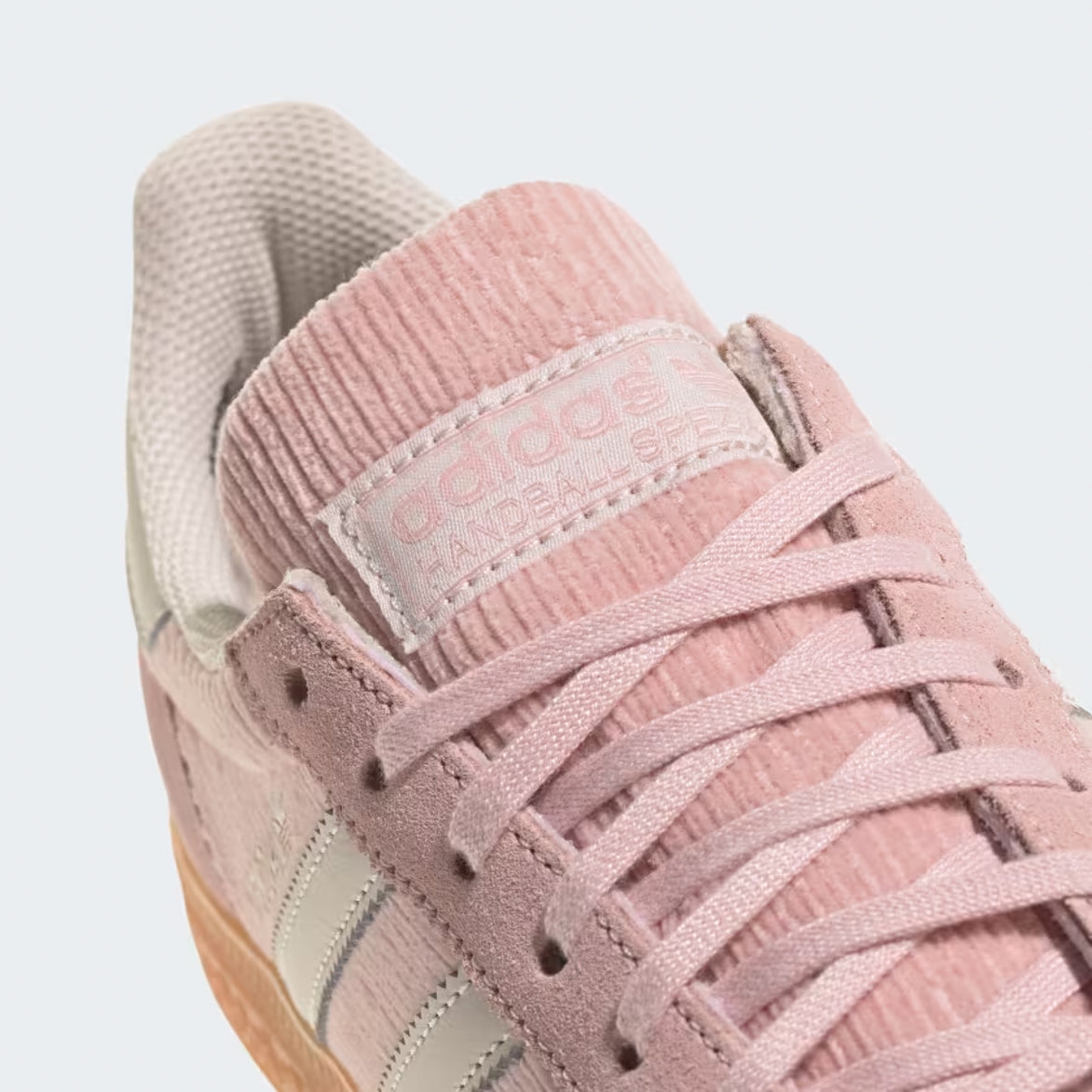 Top view of womens handball shoes in sandy pink with off-white accents.
