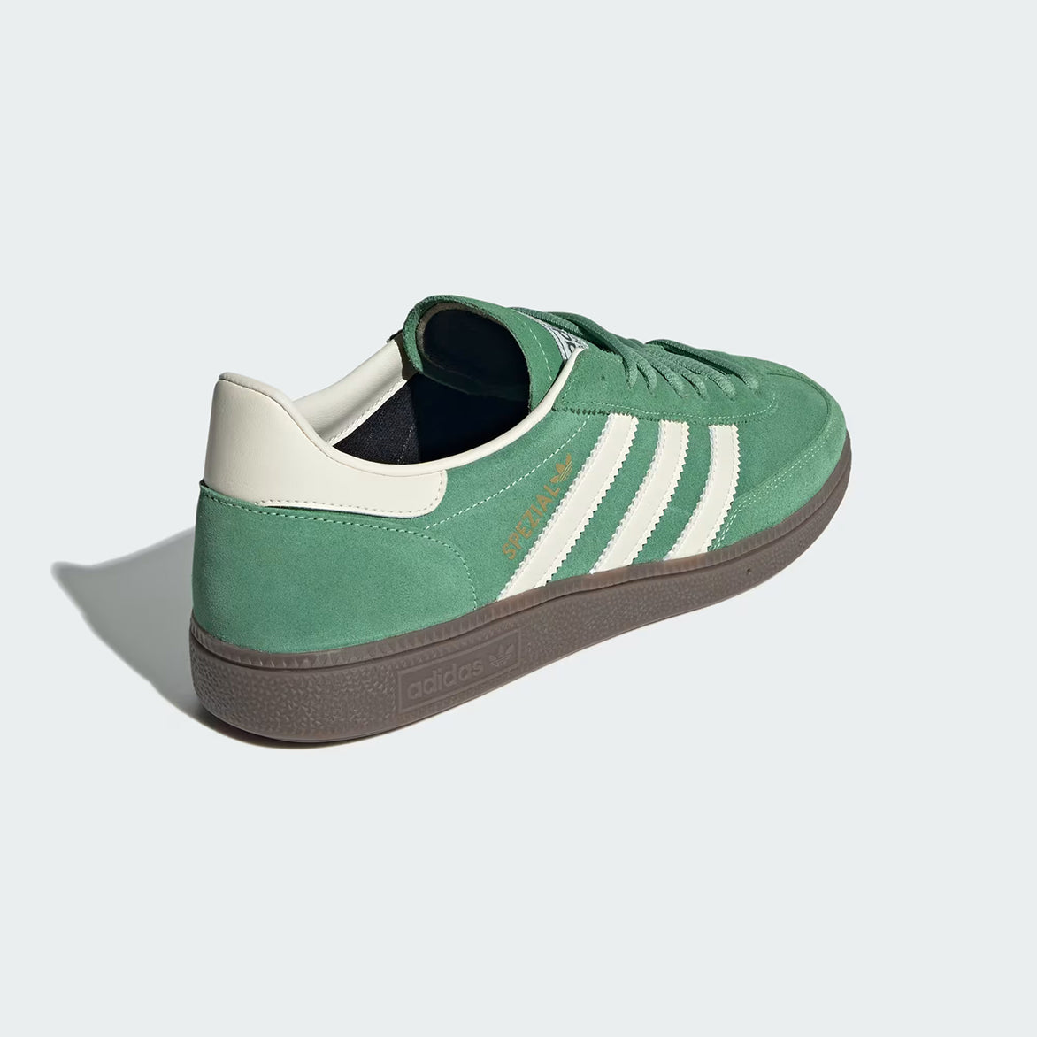 Lifestyle shot of a person wearing Handball Spezial sneakers in a casual setting, emphasizing their retro style.
