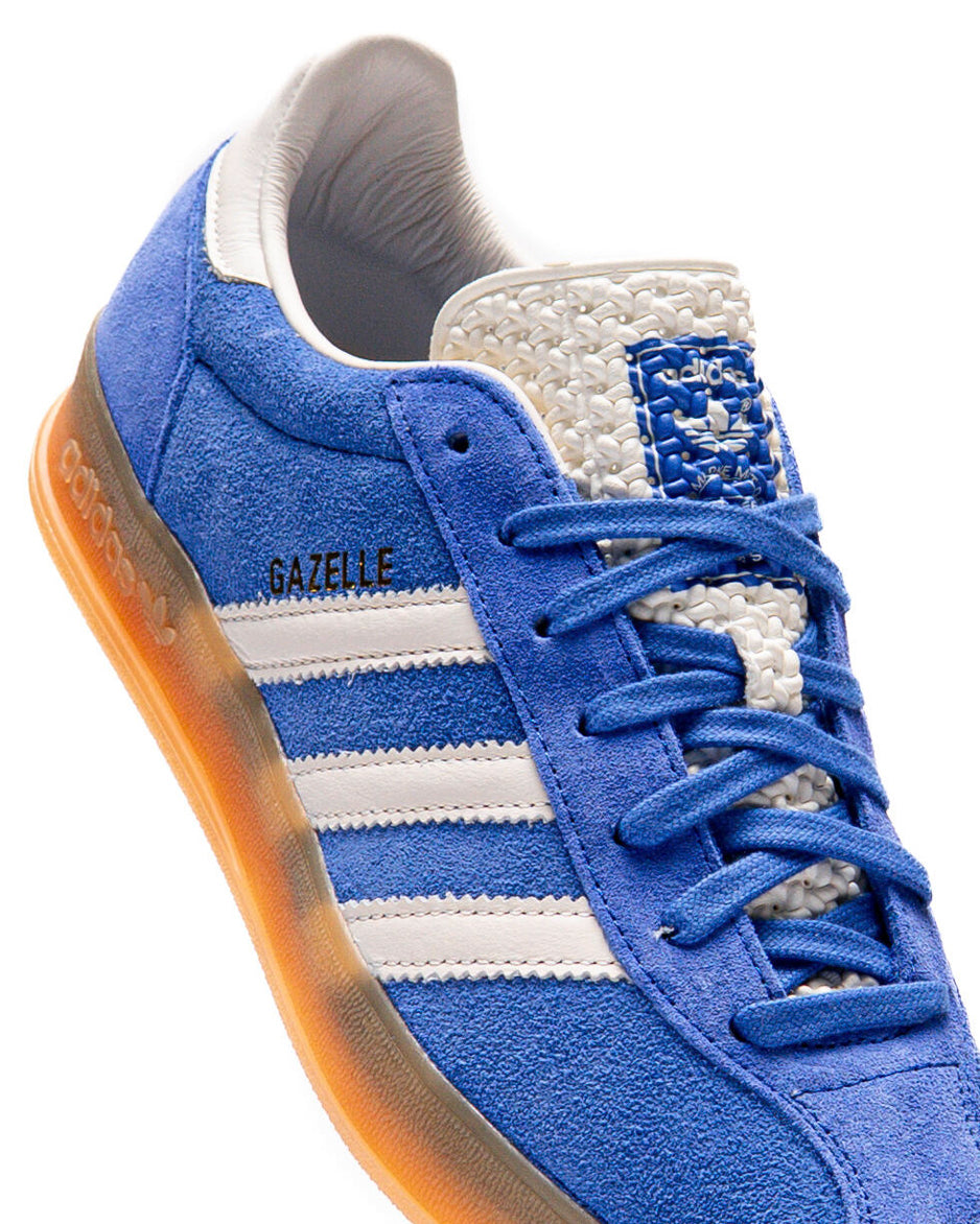 Side view of Gazelle Indoor Pro Power Blue sneakers highlighting the blue suede upper and white accents