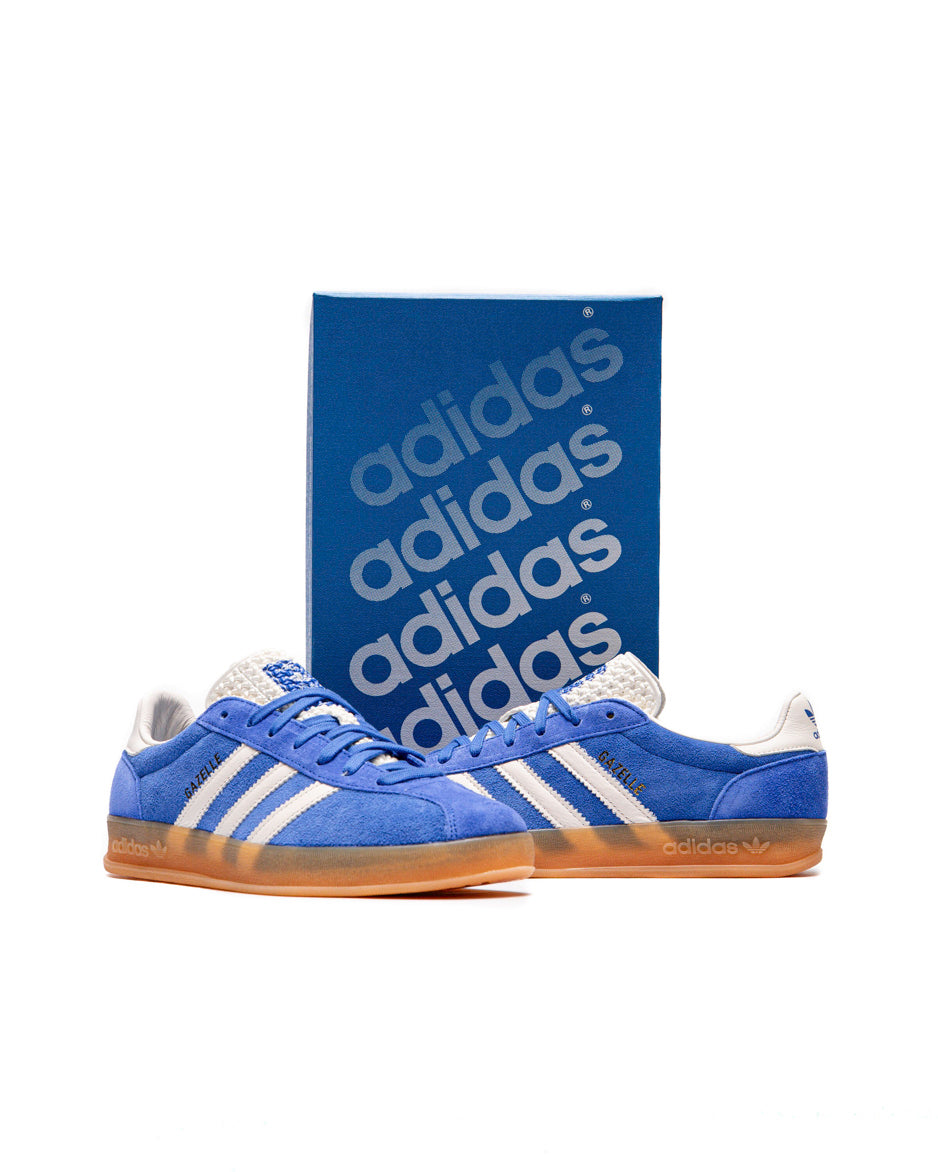 Top-down shot of the sneakers showing the blue laces and textured tongue with branding